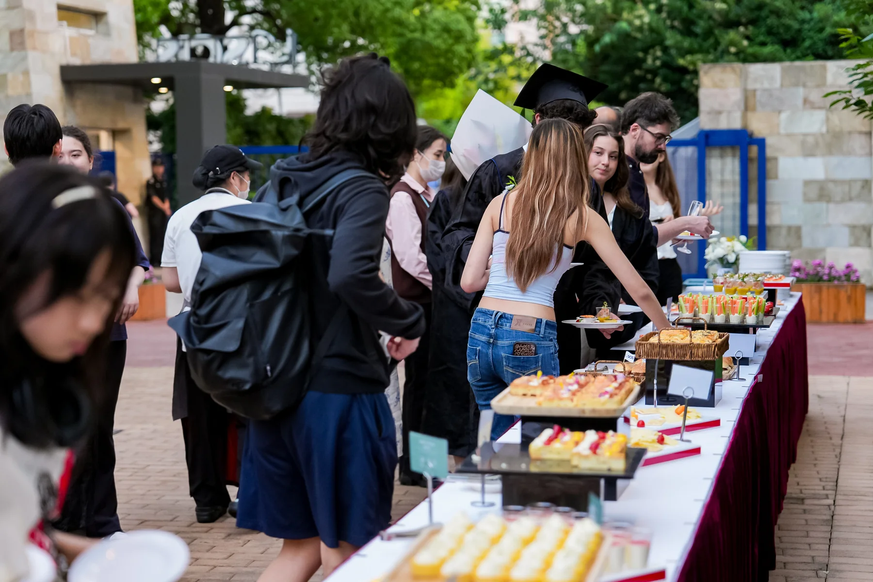 School community gathering around a catering display